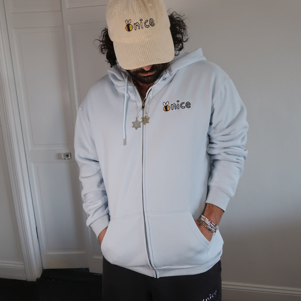 
                      
                        Bee Nice Embroidered Zip Up in Ice Blue
                      
                    